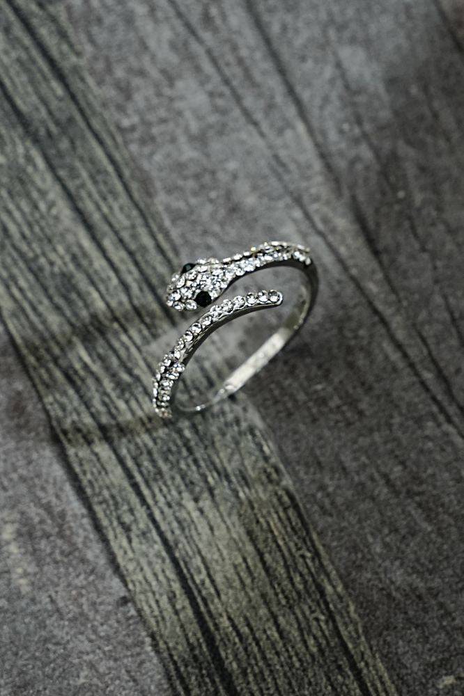 Silver snake ring RINGS JW1282 SLV with zircon stones and green eyes on textured background