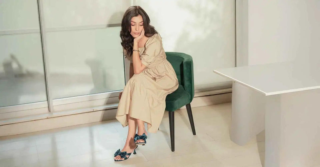 Woman trying on stylish shoes indoors at an online store for women’s shoes in Pakistan