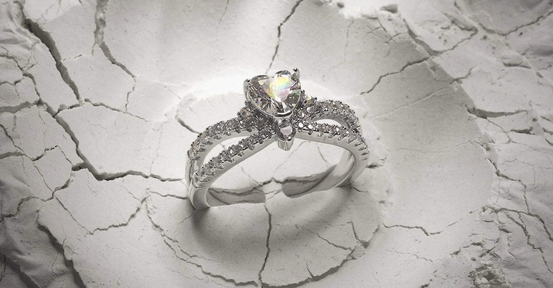 Elegant silver ring with central gemstone and sparkling details on cracked white surface, trendy women's jewellery available online in Pakistan
